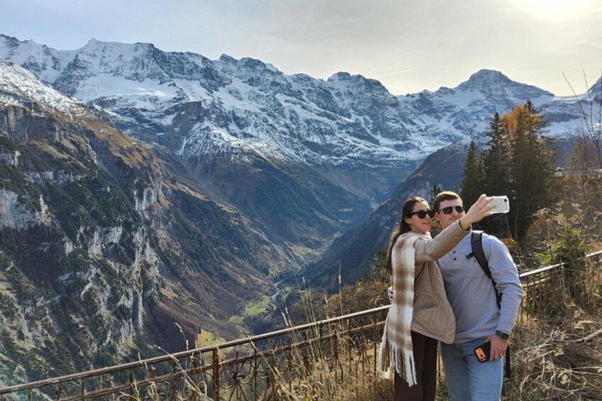 A couple taking a selfie with a mountainous landscape in the background. 5
