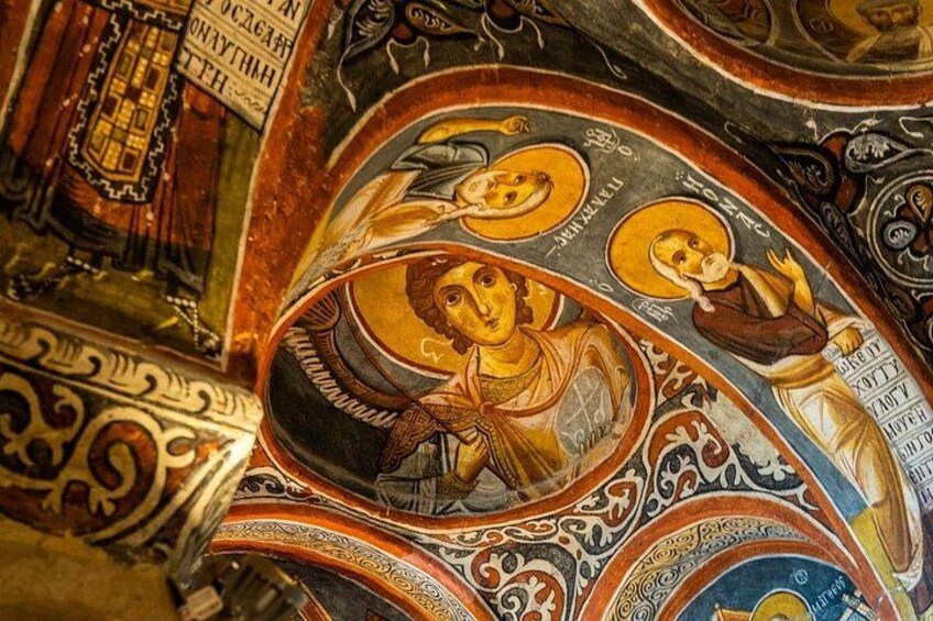 A detailed mosaic with religious figures and ornate patterns. 1