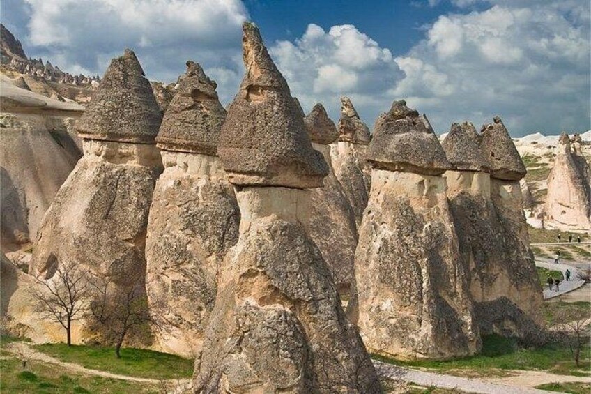 A landscape with prominent rock formations, a clear sky, and a path. 5