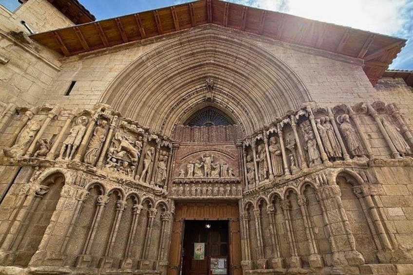 A Gothic cathedral entrance with intricate stone carvings and a pointed arch. 3