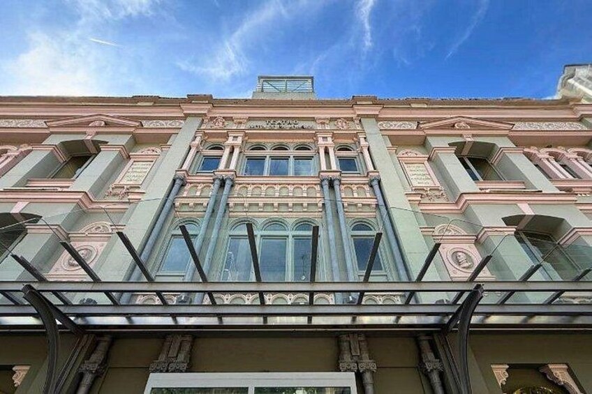 A classical building facade with ornate columns and large windows. 2