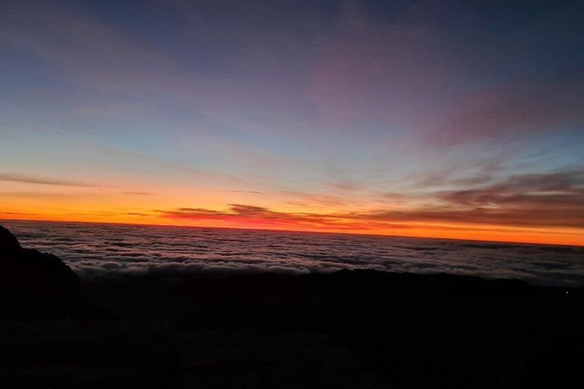A sunset over the ocean with clouds. 2