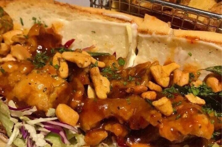 A dish with a sauce, nuts, and greens. 5