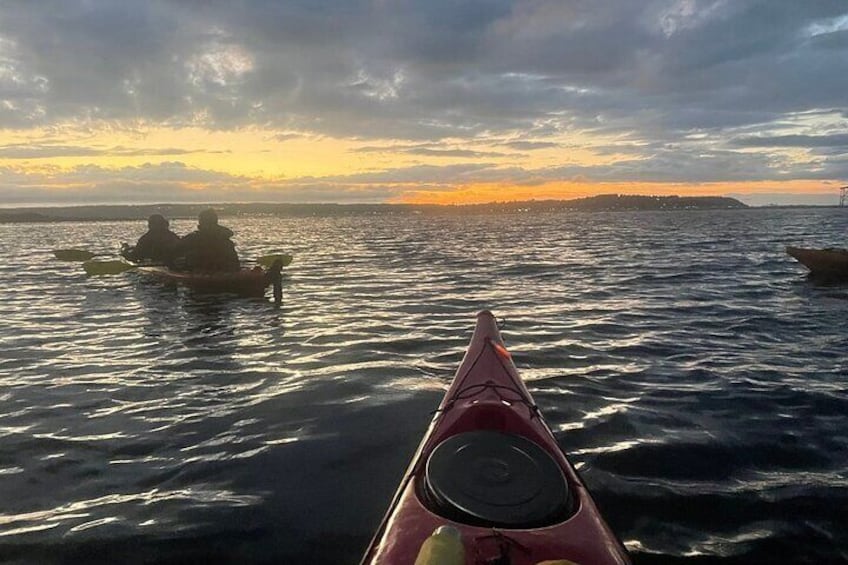 A kayak on calm water with a sunset in the background. 5