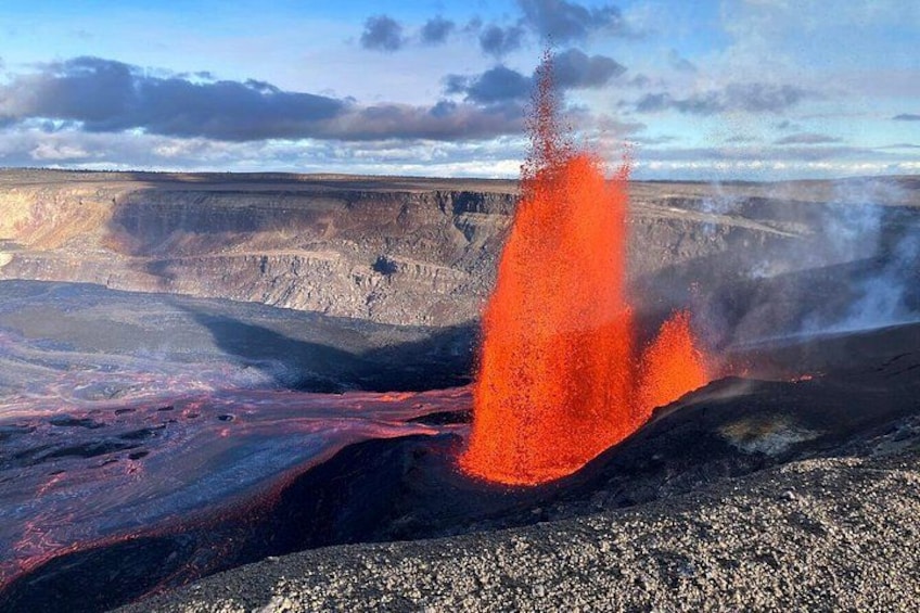 Una erupción volcánica con lava incandescente y vapor ascendiendo. 3