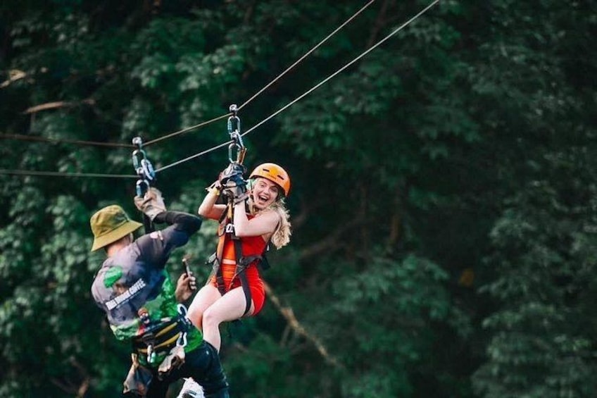 A person zip-lining through a forest. 3