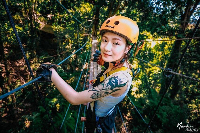A person on a zip line in a forested area. 2