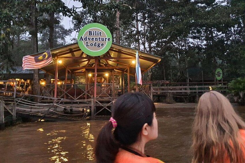 A wooden structure labeled 'Bilit Adventure Lodge' with a flag, surrounded by trees and water. 4