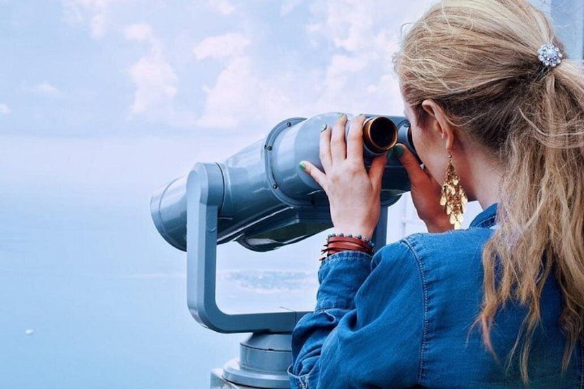 A person using a telescope. 4