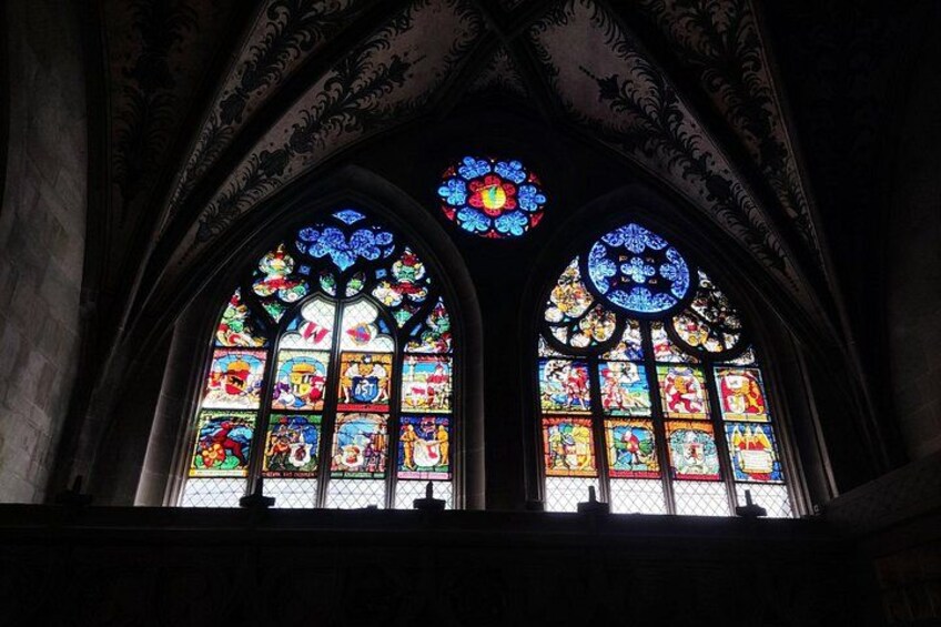 Interno di una cattedrale con due ampie vetrate istoriate e elaborate decorazioni al soffitto. 2