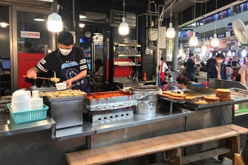 A street food vendor preparing food at a stall. 3