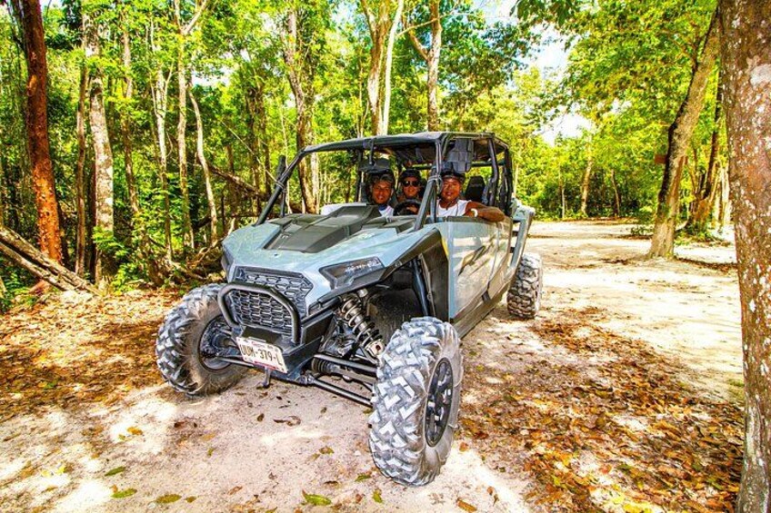 A 4x4 vehicle on a dirt path in a forest. 3