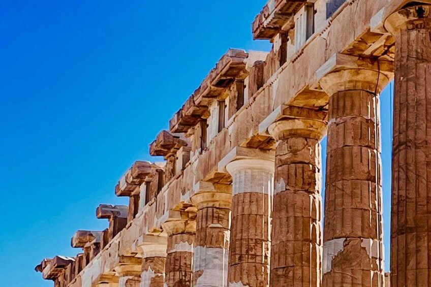 A series of ancient stone columns with capitals, likely part of a historical structure or monument. 4