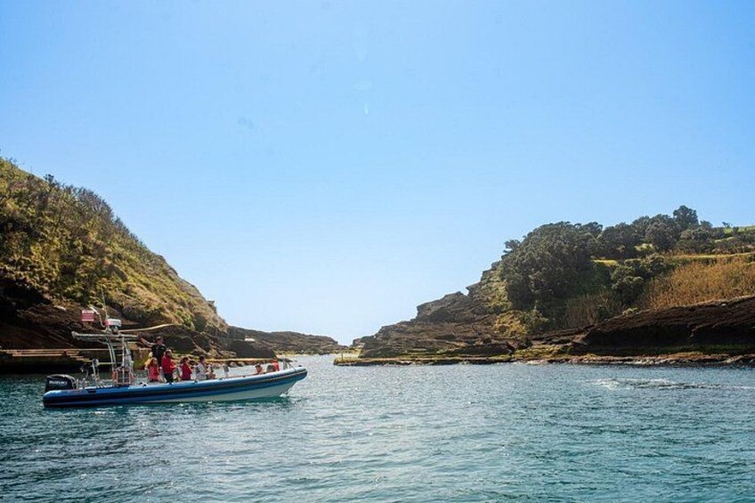 A boat on a river surrounded by hills. 3