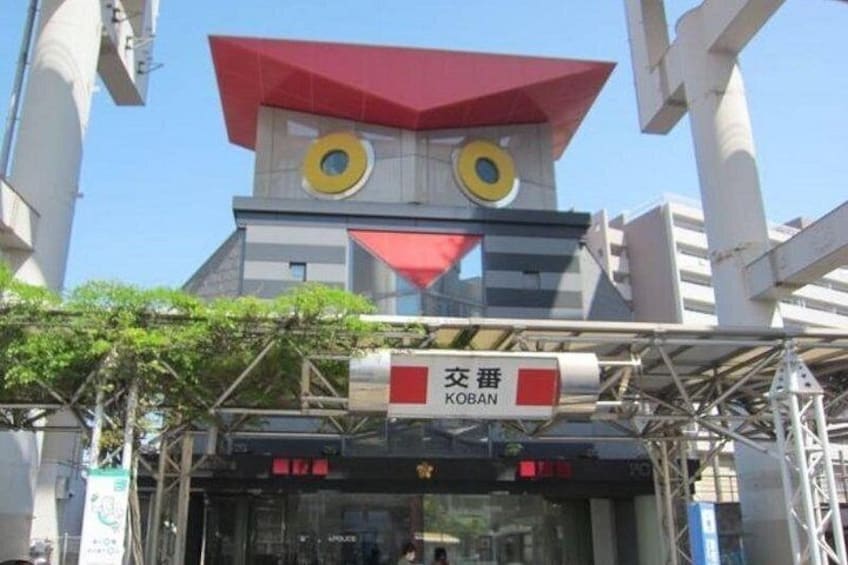 A building with a distinctive red roof and a sign reading 'KOBAN'. 2