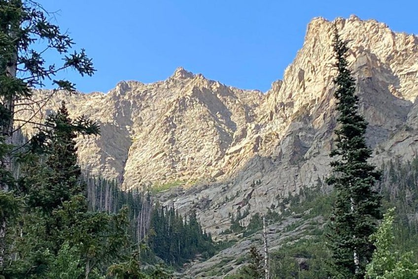 A mountainous landscape with rocky cliffs and coniferous trees. 2