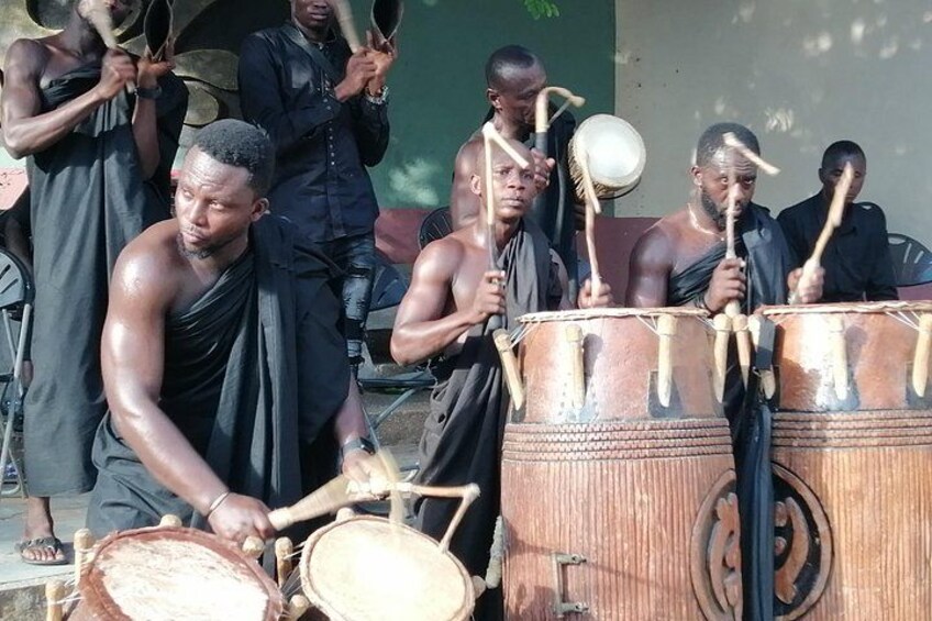 A group of people playing traditional drums. 5