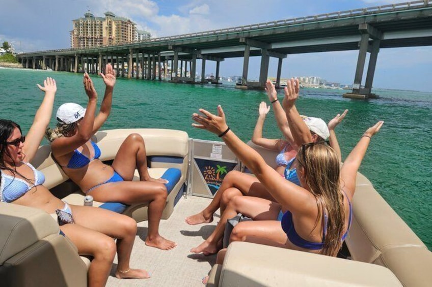 A group of people on a boat with a bridge in the background. 1