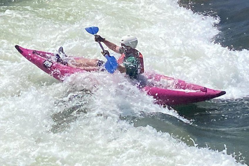 A person kayaking on a river. 5