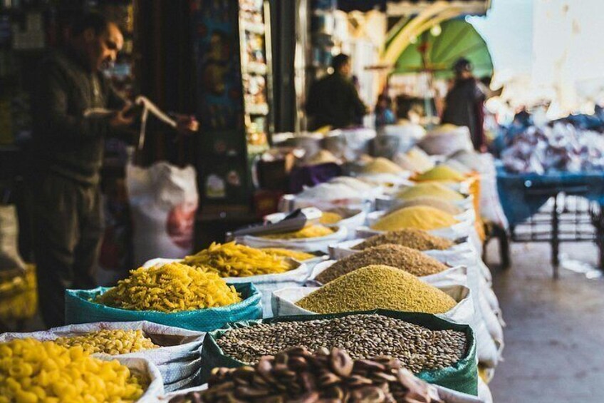 A market stall with various grains and spices. 3