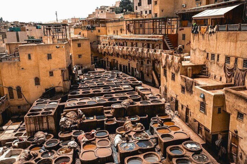 A traditional tanneries area with numerous large vats and buildings. 1
