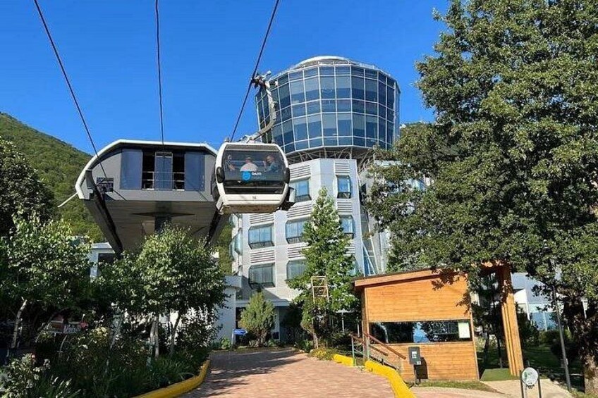 A cable car system, a modern building with a glass dome, and a wooden structure. 5