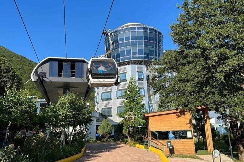 A cable car system, a modern building with a glass dome, and a wooden structure. 5