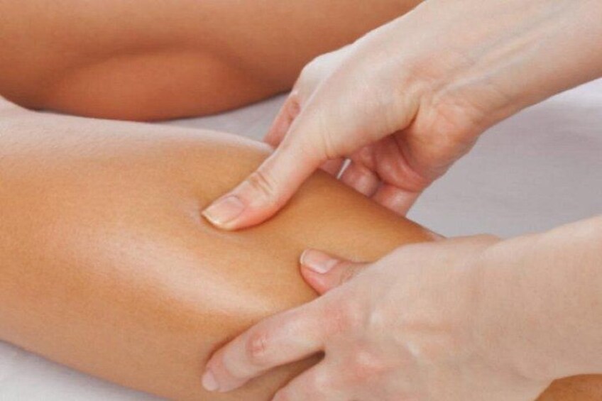 Hænder giver en massage på et ben. 2