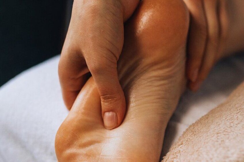 A close-up of a foot being massaged. 5