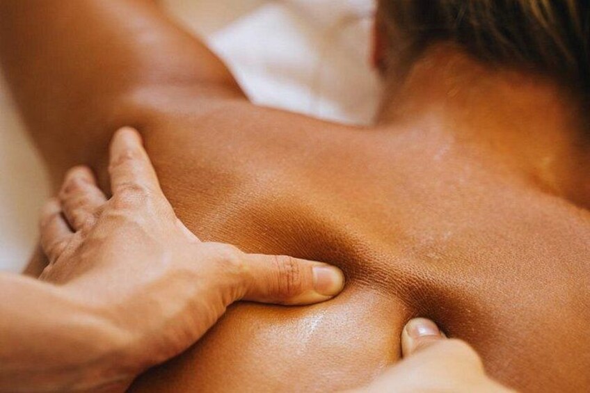 A close-up of a person's back being massaged. 2