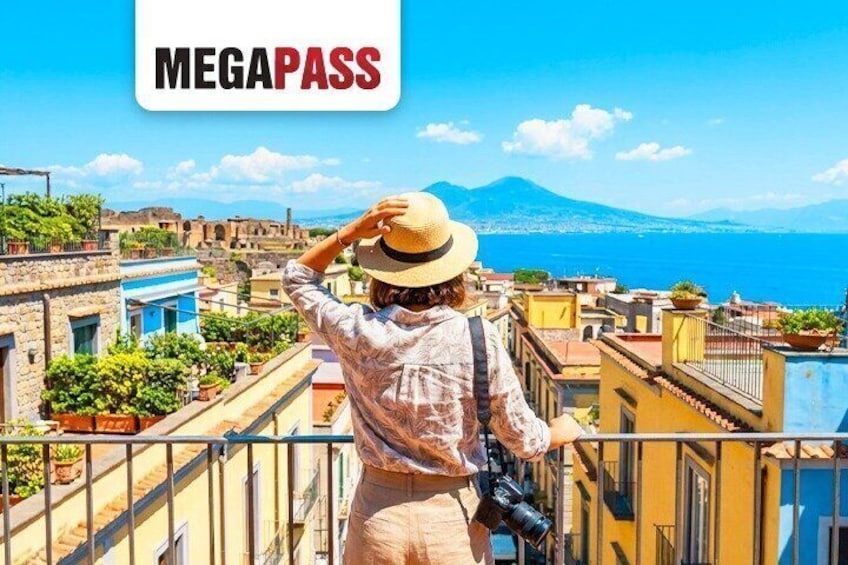 A person taking a photo of a coastal cityscape with a mountain in the background. 1