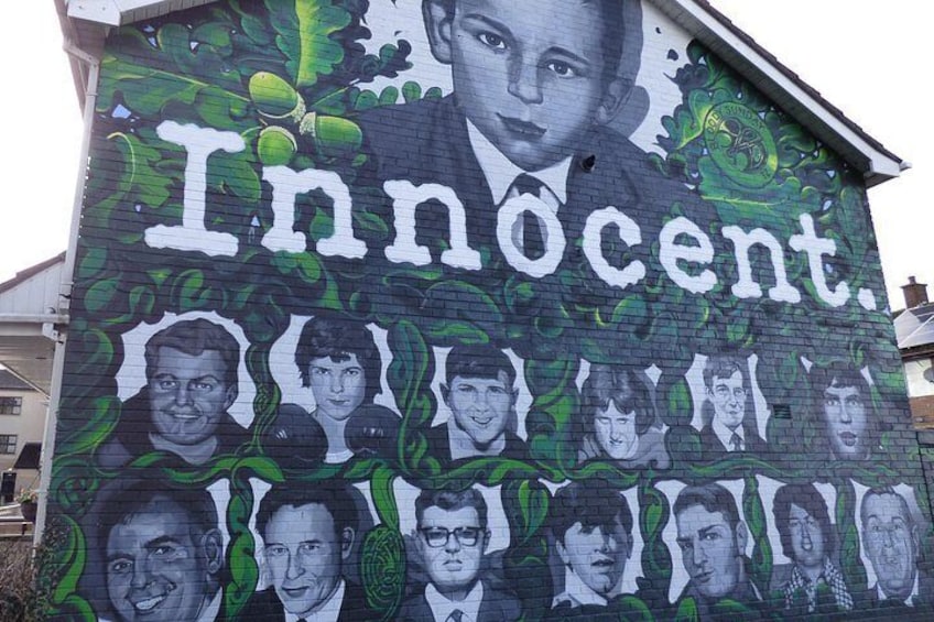 A mural on a building with the word 'Innocent.' and portraits of people. 1