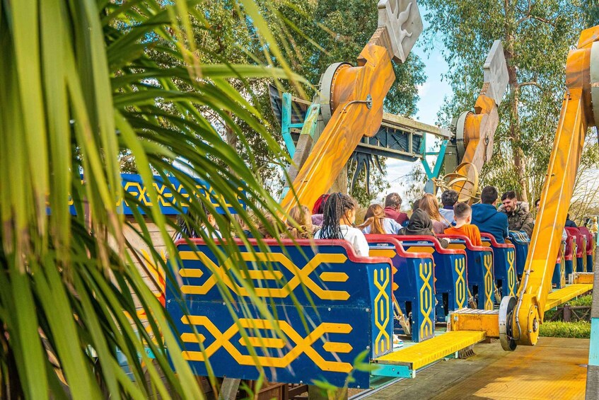 A colorful train ride with passengers, surrounded by greenery. 4