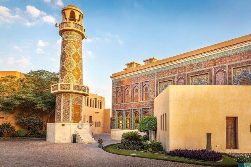 A historic building with intricate tile work and a tall minaret. 3