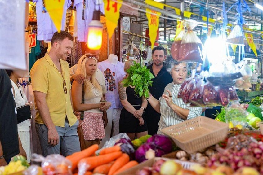 A market with various fruits and vegetables on display. 1