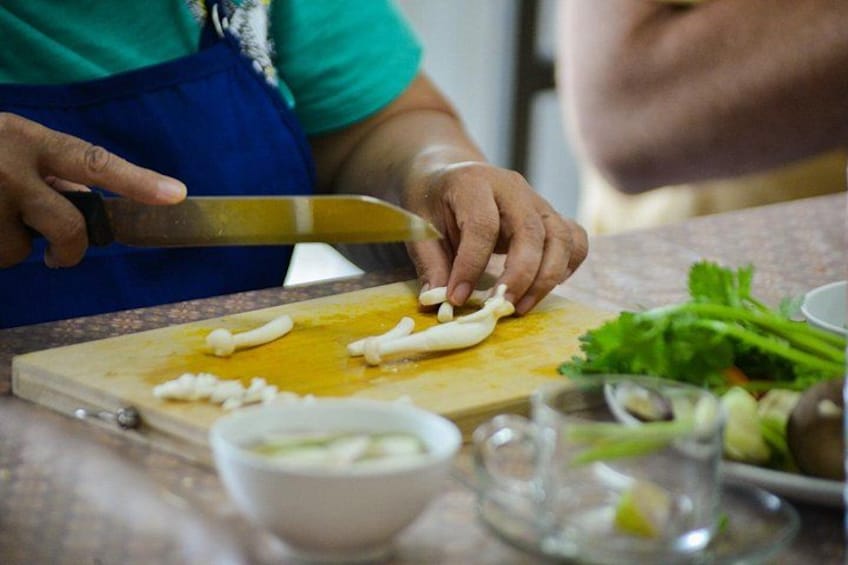 A person chopping garlic on a cutting board. 3