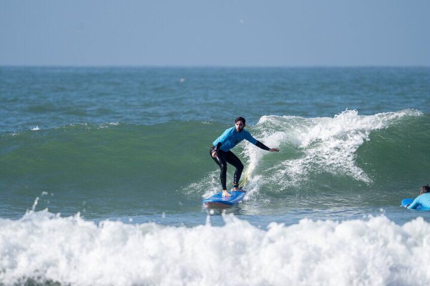 A person surfing on a wave in the ocean. 1