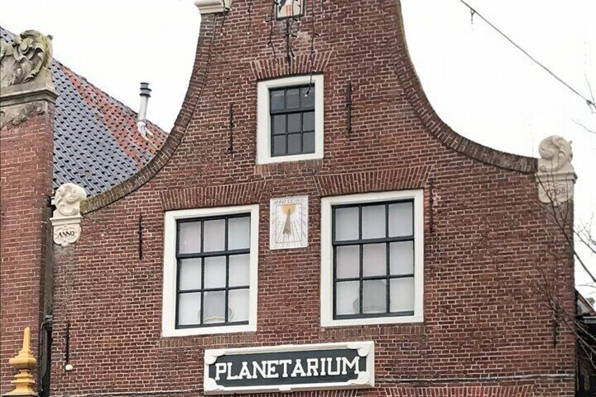 A brick building with a sign reading "PLANETARIUM". 3