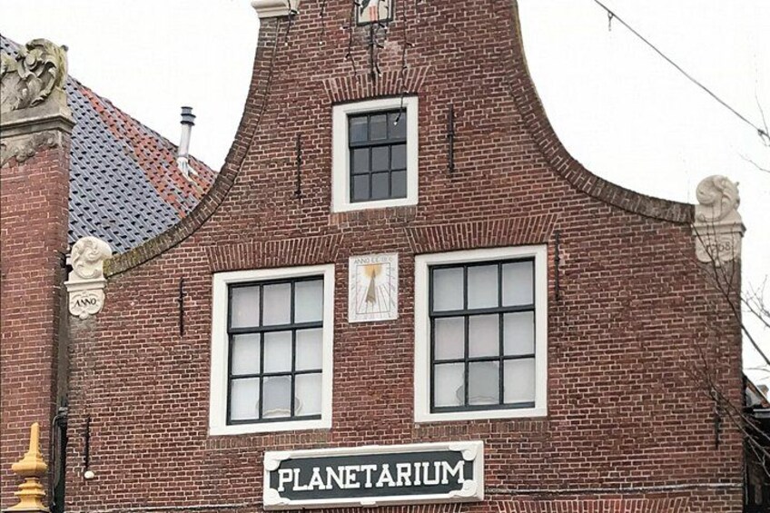 A brick building with a sign reading 'PLANETARIUM.' 3