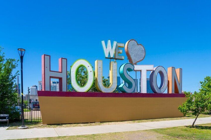 A large sign with the words "WE ♥ HOUSTON" in colorful letters. 1