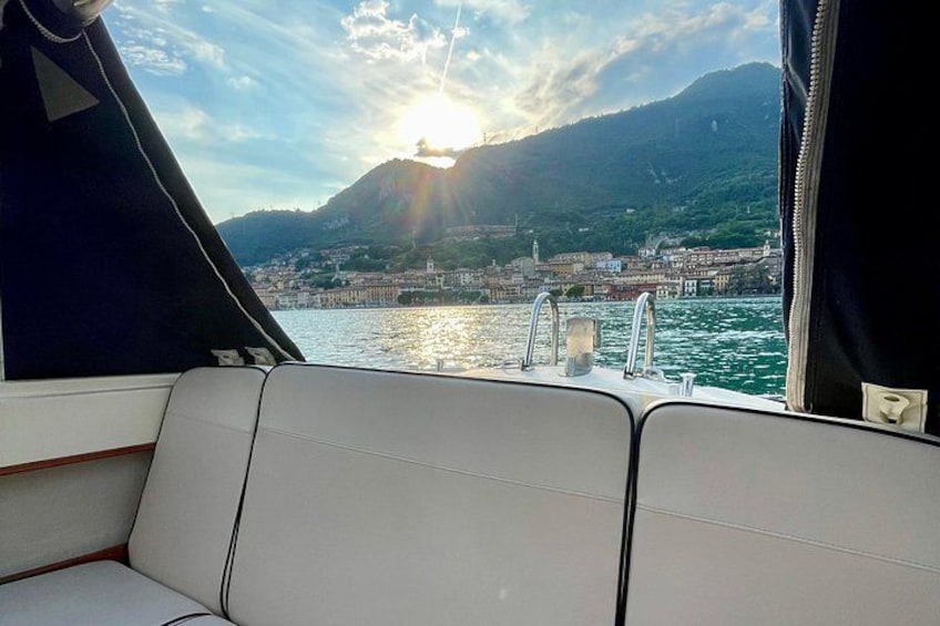 A boat's interior with a view of a coastal town and mountains in the background. 4