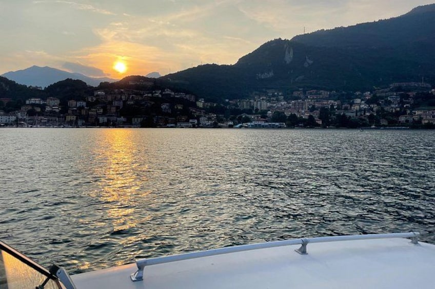 A sunset over a body of water with a cityscape in the background. 2
