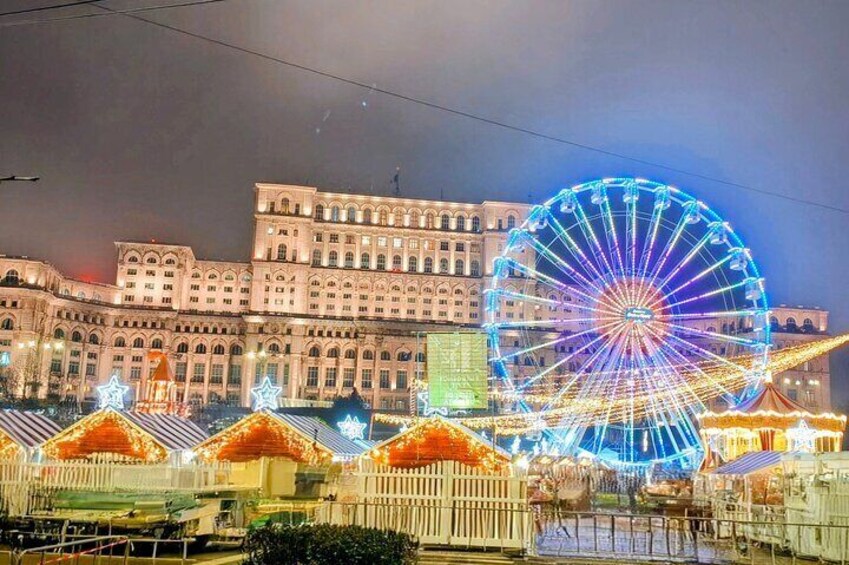 A large Ferris wheel and a historic building with ornate architecture. 2