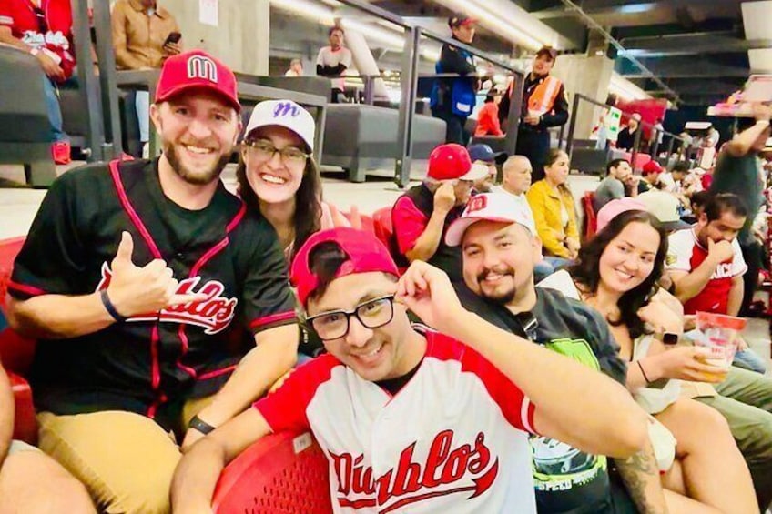 Un grupo de personas en un evento deportivo, algunas con camisetas del equipo. 2