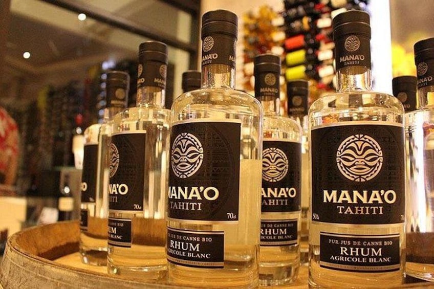 Bottles of Mana'o Tahiti rum on a wooden surface. 3