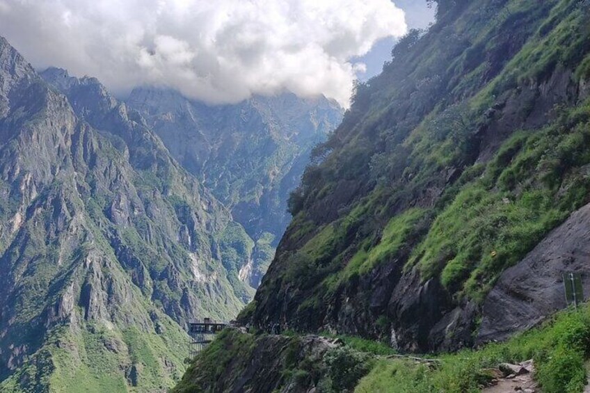 A mountainous landscape with steep cliffs and lush greenery. 2