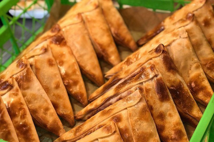 A tray of golden-brown pastries arranged in rows. 3