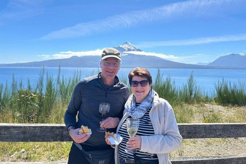 Two people standing by a lake with a mountain in the background. 5