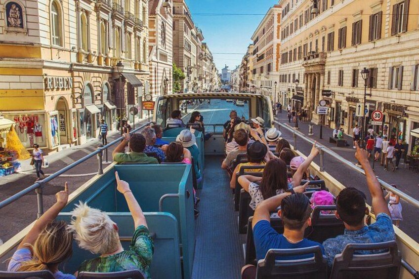 A double-decker bus with passengers enjoying the view. 2