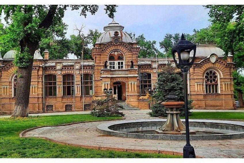 A historic building with a dome, arched windows, and a central courtyard with a fountain. 4